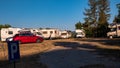 italy Abruzzo. agosto-22. 2021. White camper on campsite. Sun Rays in the morning through the trees. Many bikes and