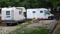 italy Abruzzo. agosto-22. 2021. White camper on campsite. Sun Rays in the morning through the trees. Many bikes and