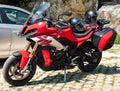 Italy, Ambruzzo - August 28, 2021 - Red sport bike with red and black wheels standing near city centre cafe on clean Royalty Free Stock Photo