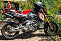 Italy, Ambruzzo - August 28, 2021 - Red sport bike with red and black wheels standing near city centre cafe on clean Royalty Free Stock Photo