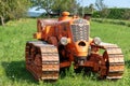 Italy. Antique tractor Orsi in a green field.