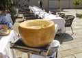 Original whole wheel of Italian cheese Grana Padano served in a restaurant in liquid form for spaghetti