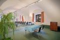 Italy, Bolzano - August 5, 2015: vaulted cellar of stylish office meeting room with white walls, green gray carpet floor, window