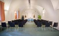 Italy, Bolzano - August 5, 2015: vaulted cellar of stylish office meeting room with white walls, green gray carpet floor, window