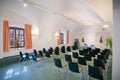 Italy, Bolzano - August 5, 2015: vaulted cellar of stylish office meeting room with white walls, green gray carpet floor, window