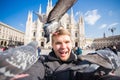 Italy, excursion and travel concept - funny guy taking selfie with pigeons in front of cathedral Duomo in Milan Royalty Free Stock Photo