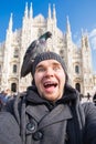 Italy, excursion and travel concept - funny guy taking selfie with pigeons in front of cathedral Duomo in Milan Royalty Free Stock Photo