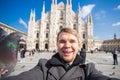Italy, excursion and travel concept - funny guy taking selfie with pigeons in front of cathedral Duomo in Milan Royalty Free Stock Photo
