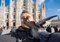 Italy, excursion and travel concept - funny guy taking selfie with pigeons in front of cathedral Duomo in Milan Royalty Free Stock Photo