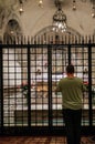 Italy. Faith and Religion. Bari. Basilica of San Nicola. A man prays in front of the chapel with the relics of the saint in cripta