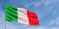 Italy flag on flagpole on blue sky background. Italian flag waving in the wind on a background of sky with clouds. Place for text Royalty Free Stock Photo