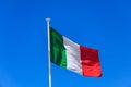 Italy flag. Italian flag on a pole waving on blue sky background Royalty Free Stock Photo
