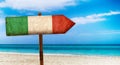 Italy flag on wooden table sign on beach background. It is summer sign of Italy