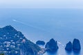 Italy. Island Capri. Faraglioni rocks and boats from Monte Solar