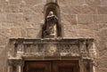 Italy, the island of Sardinia. The city of Alghero. An ancient church in the old medieval city. A carved surround to a door. Royalty Free Stock Photo