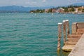 Italy - Lake Garda. Blue waters are lush greenery of Italian nature and the mighty slopes of the Alpine mountains.