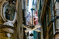 Italy. Liguria. Genoa. Votive altar and suspended street signs in an alley of the medieval town