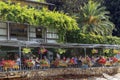 People dine on the open veranda of a restaurant on Lake Maggiore