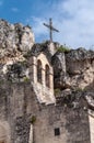 Italy. Matera. Ancient rupestrian Church of Santa Maria de Idris, 12th century. External. The simple belfry and the iron cross Royalty Free Stock Photo