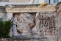 Italy. Matera. The medieval Porta de Suso, the upper gate, from Via Duomo. Artistic relief with male head on the balustrade