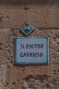 Italy. Matera. Sasso Caveoso. Church of San Pietro Caveoso, 13th century. Ceramic tile with Matera crest and toponymy plaque