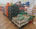 boxes of beer cans and other soft drinks in plastic bottles on pallets