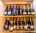 bottles of Champagne and Italian sparkling wines in wine cellar cabinet