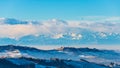 Italy Piedmont: Barolo wine yards unique landscape winter sunset, La Morra medieval village castle on hill top, the Alps snow Royalty Free Stock Photo