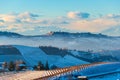 Italy Piedmont: Barolo wine yards unique landscape winter sunset, La Morra medieval village castle on hill top, the Alps snow Royalty Free Stock Photo