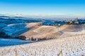 Italy Piedmont: wine yards unique landscape winter sunset, Serralunga d`Alba medieval village castle on hill top, the Alps snow Royalty Free Stock Photo