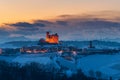 Italy Piedmont: wine yards unique landscape winter sunset, Serralunga d`Alba medieval village illuminated castle on hill top, the Royalty Free Stock Photo