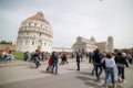 ITALY, PISA 22-04-2019: tourists walking near the sights and lying on the grass