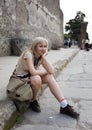 Italy. Pompeii. The woman the tourist has a rest on the street of the destroyed city