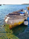 Ancient wooden fishing boat in Italian dock Royalty Free Stock Photo