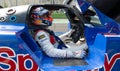 Driver in racing suit and helmet sitting in prototype race car cockpit Royalty Free Stock Photo