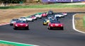 60s vintage race cars large group competition on racetrack, formation lap with Royalty Free Stock Photo