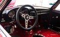 Vntage car cockpit steering wheel and dashboard with Alfa Romeo logo