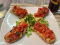 Famous bruschetta on a white plate in a restaurant in Italy Royalty Free Stock Photo