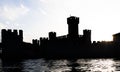 Italy - Sirmone castle silhouette on the Garda lake at sunset. Medieval architecture with tower