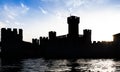 Italy - Sirmone castle silhouette on the Garda lake at sunset. Medieval architecture with tower