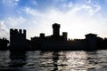 Italy - Sirmone castle silhouette on the Garda lake at sunset. Medieval architecture with tower