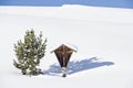 Italy, South Tyrol, Seiseralm, Wayside shrine in snowy landscape Royalty Free Stock Photo