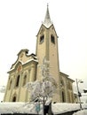 Italy, Trentino Alto Adige, Bolzano, San Vigilio di Marebbe, view of the church of the town during a winter day and during a snowf Royalty Free Stock Photo