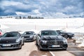 Italy, Trentino, 29 April 2019: The group of luxury sports cars does a stop on the twisting road, snow-covered field on Royalty Free Stock Photo