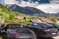Italy, Trentino, 29 April 2019: Solar panels on the roof top through the most powerful luxury cars, mountains Dolomites