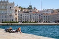 Italy, Trieste, a tourist lying in the sun on the daring pier