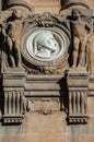 Dante Alighieri marble medal, between two stone puttos