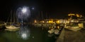 Italy, Tuscany Maremma Castiglione della Pescaia, fireworks over the sea, panoramic night view of the port and the castle Royalty Free Stock Photo