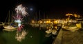 Italy, Tuscany Maremma Castiglione della Pescaia, fireworks over the sea, panoramic night view of the port and the castle Royalty Free Stock Photo