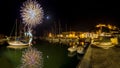 Italy, Tuscany Maremma Castiglione della Pescaia, fireworks over the sea, panoramic night view of the port and the castle Royalty Free Stock Photo